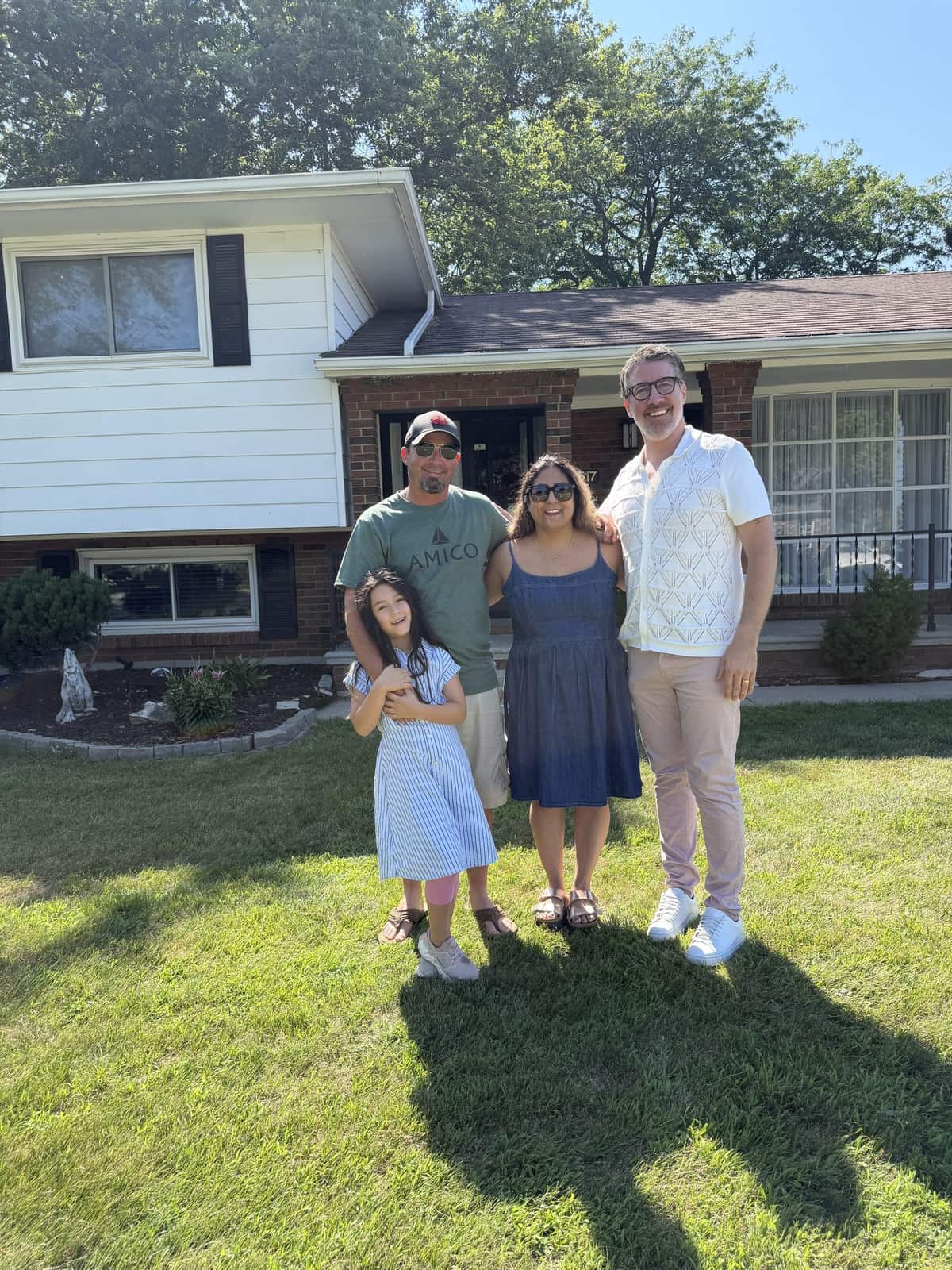 Matt Biggley with clients outside their two-storey home in Windsor-Essex