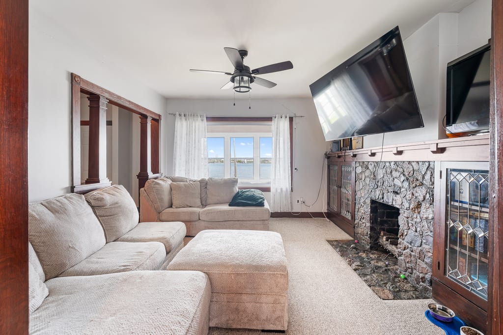 Main-floor living room with original woodwork and fireplace