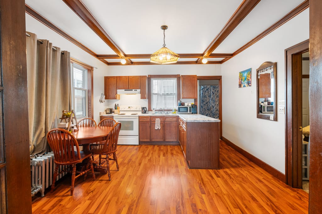 Main-floor kitchen and dining room with original wood trim