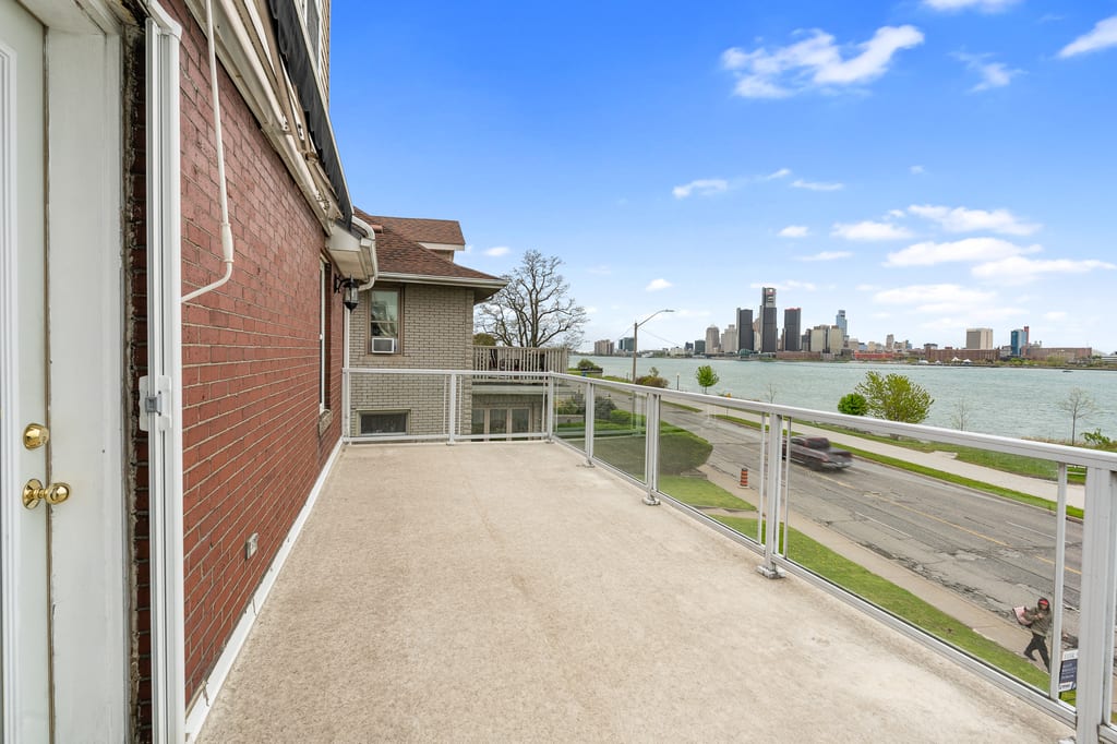Long upper porch overlooking the Detroit River and skyline