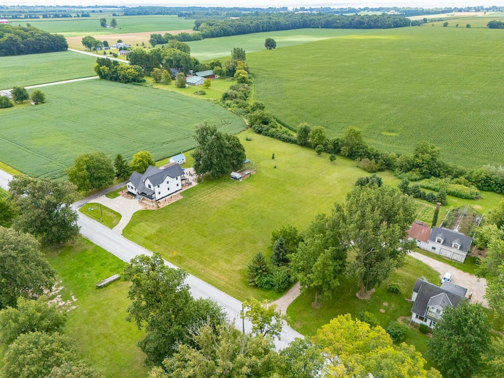 Aerial view of 1677 Huffman Road surrounded by farm fields and open country