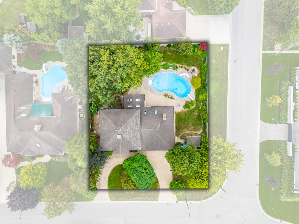 Overhead aerial showing the full corner lot outline, pool, driveway, and neighbouring streets
