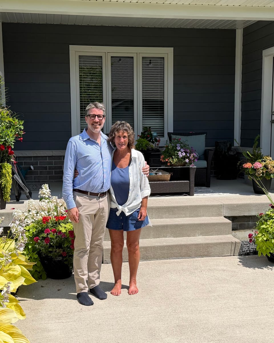 Matt Biggley with a client on the front porch of her home in Windsor-Essex