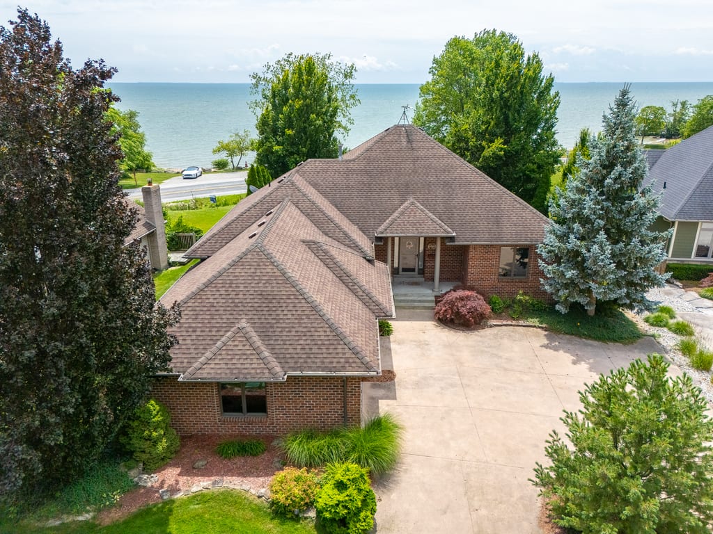 Aerial view of the brick ranch at 501 Lake Drive with Lake Erie directly beyond it