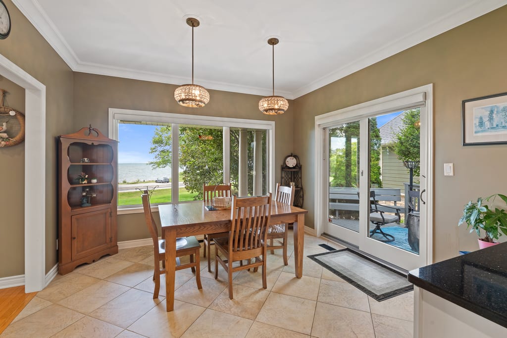 Dining area with windows on two sides looking out toward the lake
