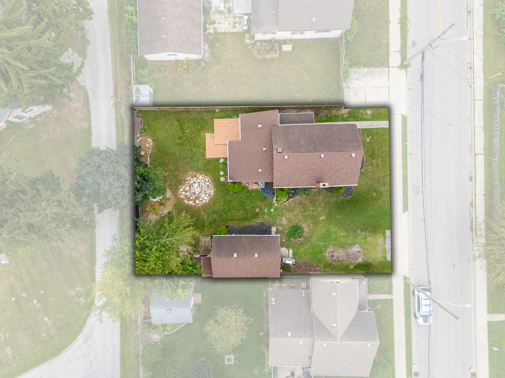 Overhead aerial with the property outlined, showing the house, rear deck, fire pit, and detached garage