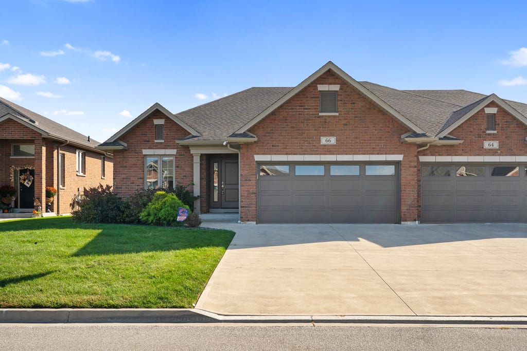 Brick ranch semi-detached home at 66 York Boulevard with a covered front entry, a double garage, and a wide concrete drive