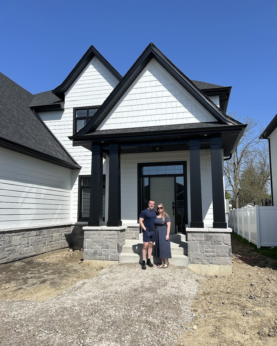 Clients on the front steps of the home they bought in Windsor-Essex